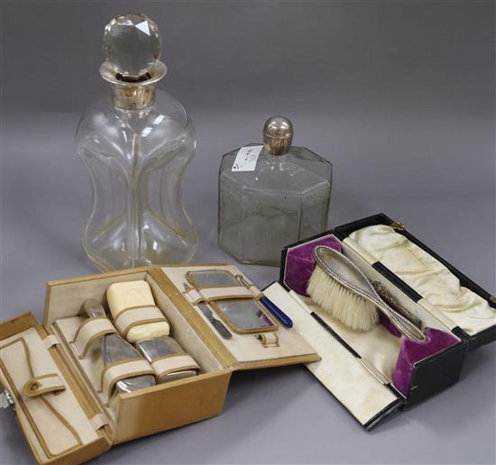 A silver collared glass decanter (af) and one other decanter, a vanity case and cased silver brush & comb.